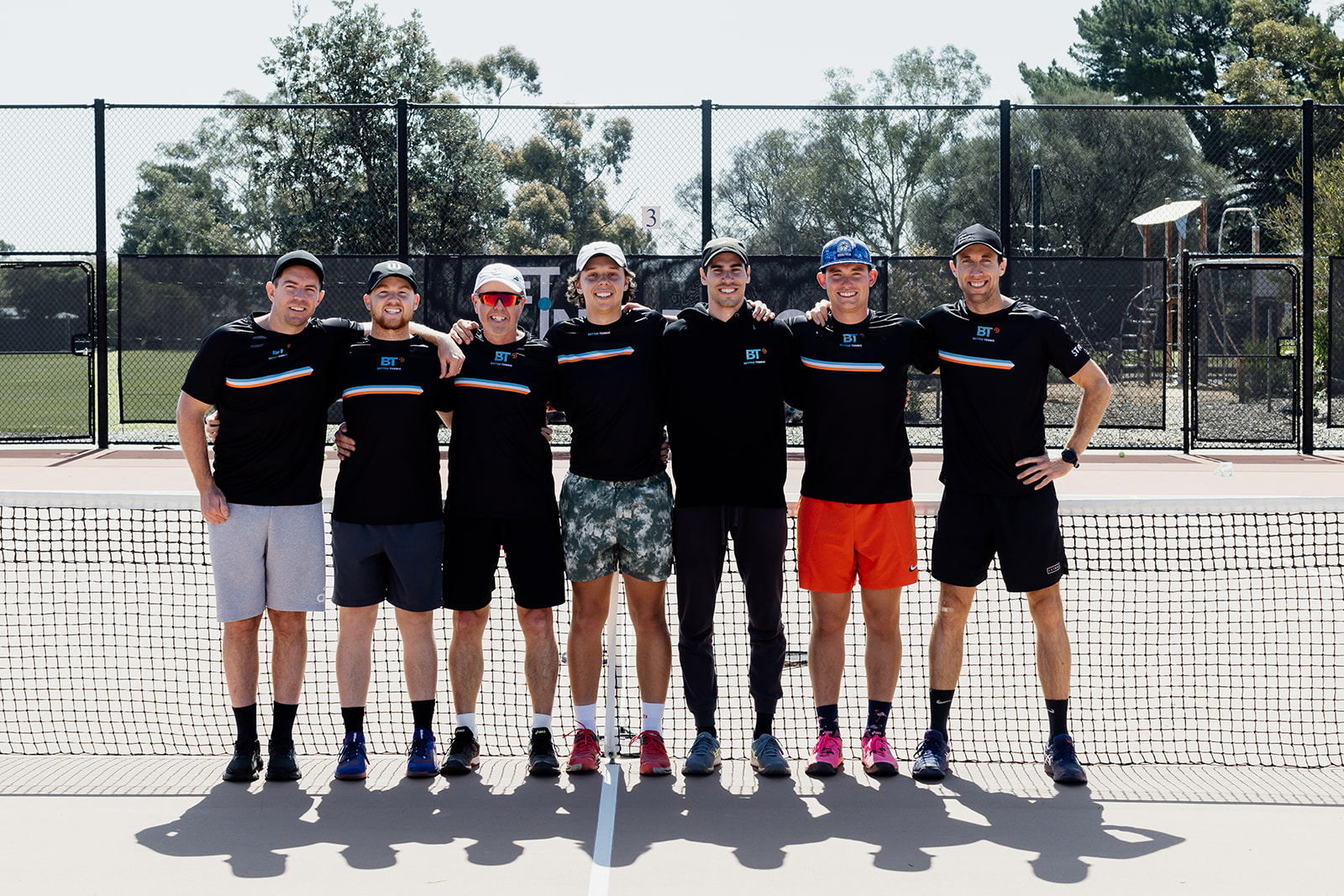 Better Tennis Plus coaches standing together on court
